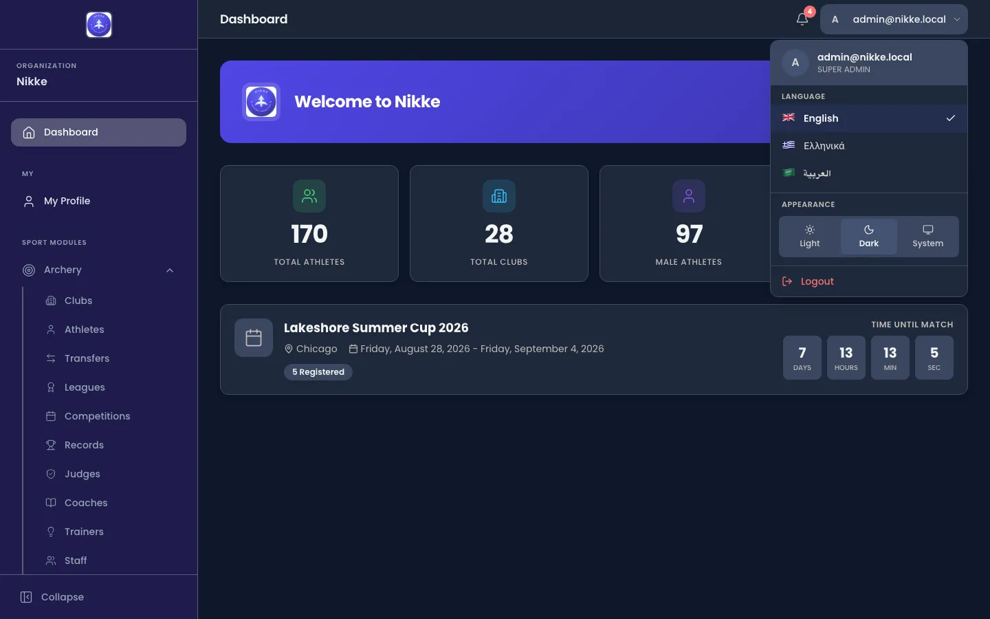 The Velos account menu open over the dashboard, showing the signed-in email address with the account type beneath it, a Language section listing English, Greek and Arabic, an Appearance section with Light, Dark and System, and a Logout item.