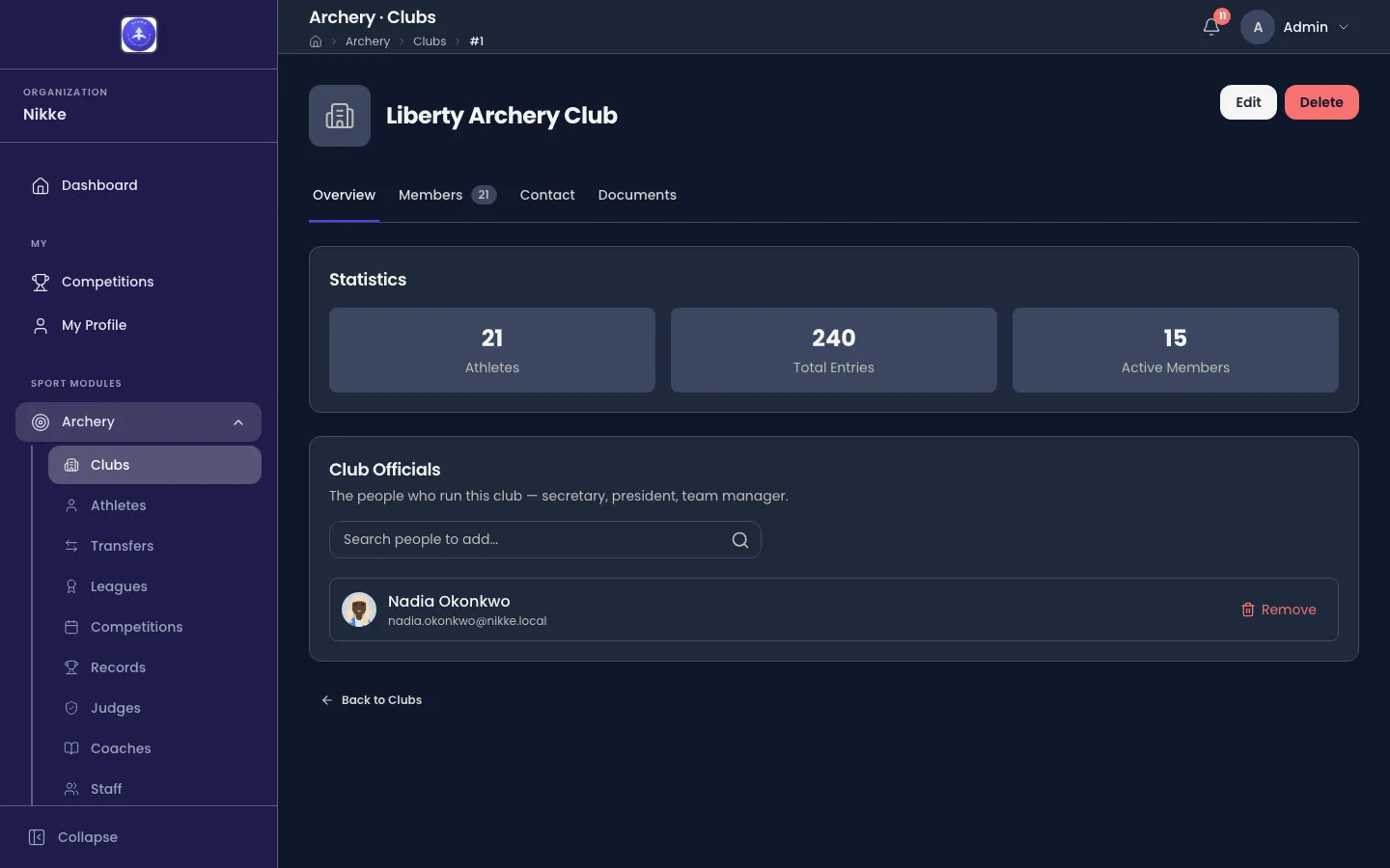 The Overview tab of Liberty Archery Club in Velos, with Edit and Delete buttons at the top right, a row of tabs reading Overview, Members 21, Contact and Documents, a Statistics card holding three tiles: 21 Athletes, 240 Total Entries and 15 Active Members, and a Club Officials card beneath it listing Nadia Okonkwo with a search box for adding people and a Remove action.