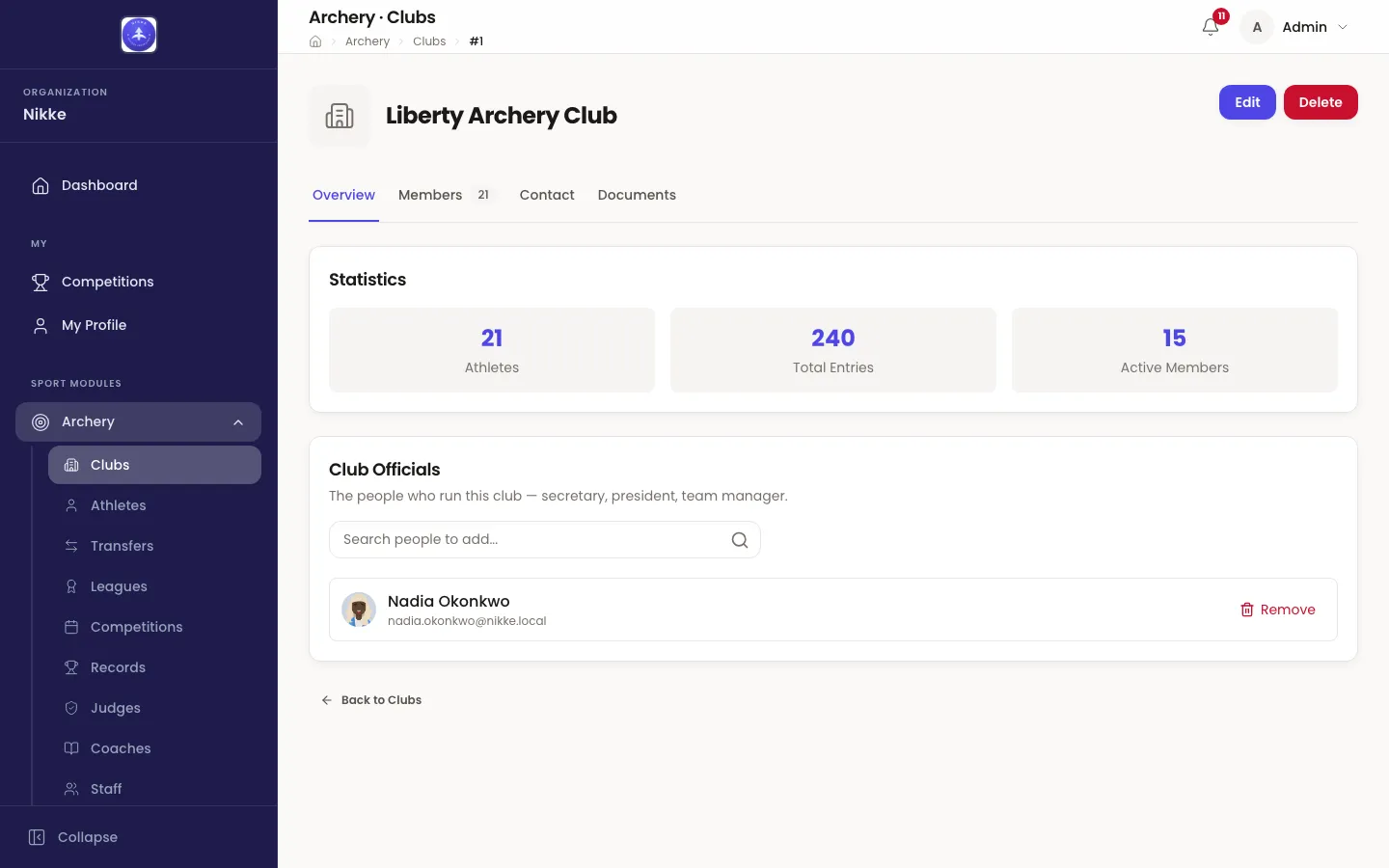The Overview tab of Liberty Archery Club in Velos, with Edit and Delete buttons at the top right, a row of tabs reading Overview, Members 21, Contact and Documents, a Statistics card holding three tiles: 21 Athletes, 240 Total Entries and 15 Active Members, and a Club Officials card beneath it listing Nadia Okonkwo with a search box for adding people and a Remove action.